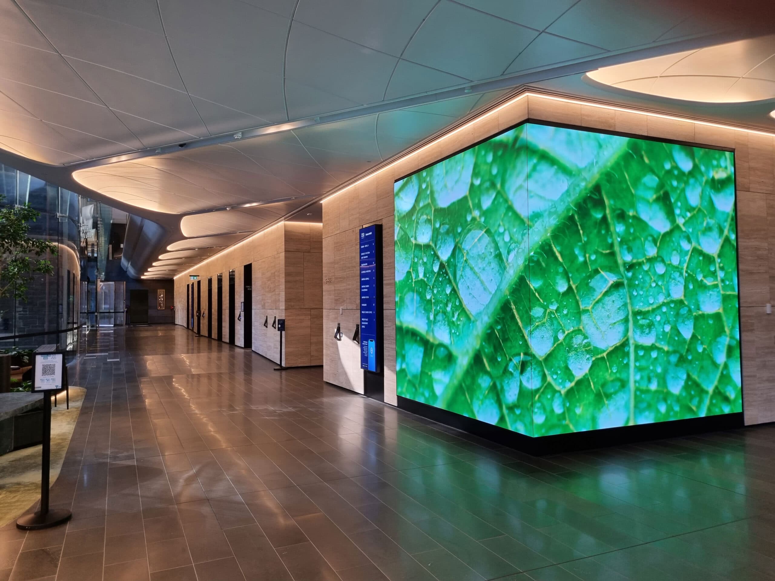 Curved indoor LED display installed in a modern commercial interior